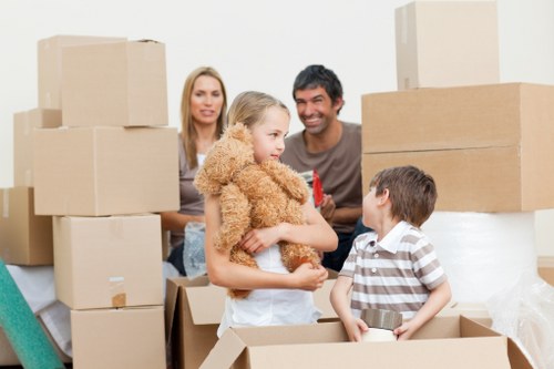 Professional movers carefully carrying furniture through a residential property in Blackfriars